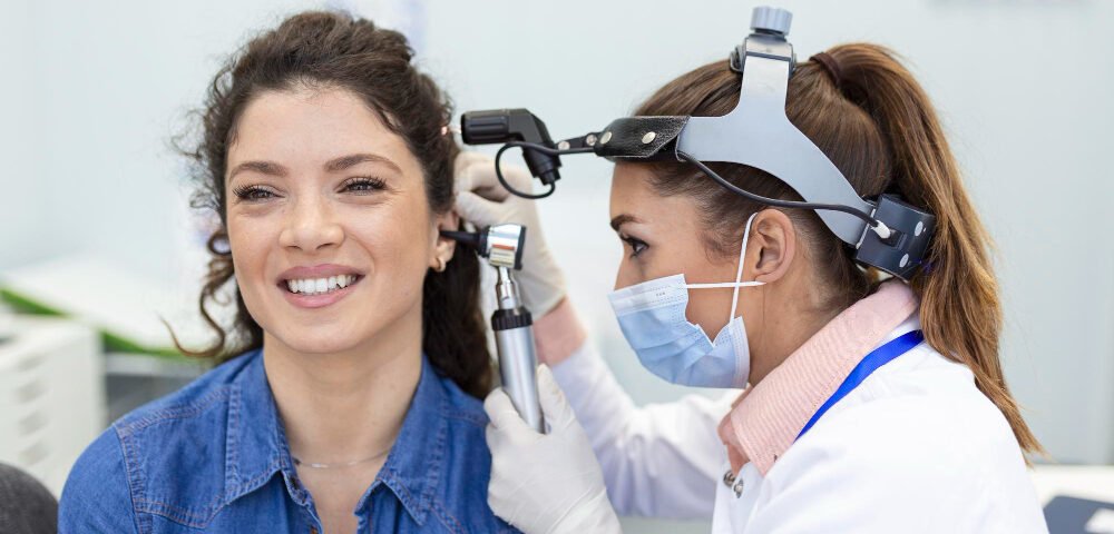 A woman in Mumbai receives an ear examination from a doctor, highlighting her ear piercing.jpg